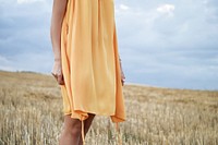 Woman standing amidst a field in autumn. Original public domain image from Wikimedia Commons