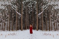 A woman with long hair in a red dress stands at the entrance of a snowy forest. Original public domain image from Wikimedia Commons