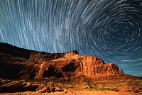 A blurry background image that perfectly captures swirling stars in a night sky over Lake Powell. Original public domain image from Wikimedia Commons