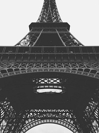 A black-and-white shot of the bottom of the Eiffel Tower. Original public domain image from <a href="https://commons.wikimedia.org/wiki/File:Eiffel_Tower_bottom_view_(Unsplash).jpg" target="_blank" rel="noopener noreferrer nofollow">Wikimedia Commons</a>
