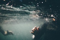 Underwater photo of person wearing black shirt. Original public domain image from Wikimedia Commons