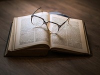 Framed eyeglasses on top open book. Original public domain image from <a href="https://commons.wikimedia.org/wiki/File:Dariusz_Sankowski_2015_(Unsplash).jpg" target="_blank">Wikimedia Commons</a>