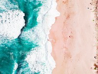 Drone aerial view of the ocean washing on the sand beach in California. Original public domain image from Wikimedia Commons