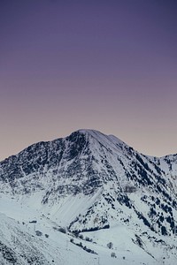 A snow-covered mountain against a light purple sky. Original public domain image from <a href="https://commons.wikimedia.org/wiki/File:Winter_in_gradient_(Unsplash).jpg" target="_blank" rel="noopener noreferrer nofollow">Wikimedia Commons</a>