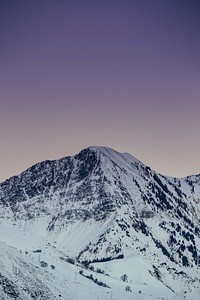 A snow-covered mountain against a light purple sky. Original public domain image from Wikimedia Commons