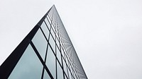 An angular shot of a tall glass facade in Boston. Original public domain image from <a href="https://commons.wikimedia.org/wiki/File:Tall_building_and_dark_lines_(Unsplash).jpg" target="_blank" rel="noopener noreferrer nofollow">Wikimedia Commons</a>