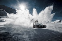 A snowboarder hitting the powdery snow hard in Davos. Original public domain image from Wikimedia Commons