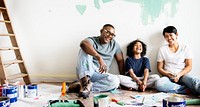 Black family painting house wall for interior design