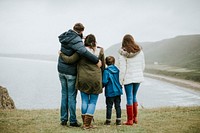 Parents with their children looking at the ocean