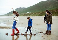 Kids walking on stones at the beach