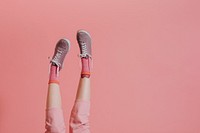 Woman legs in pink pants up in the air