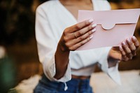 Woman reading a wedding invitation card