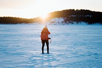 Woman with a backpack trekking through the snow