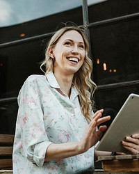 Happy woman using a digital tablet outdoors