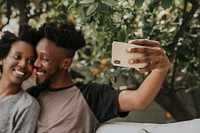 Romantic couple taking a selfie in the garden