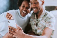 Cheerful black couple taking a picture