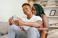 Happy lesbian couple playing on the phone