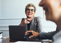 Cheerful short blond-haired businesswoman in a meeting
