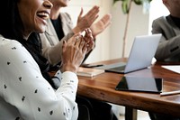 Happy business people clapping in the conference room