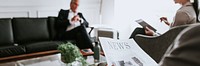 Busy businessman reading a newspaper in the lounge