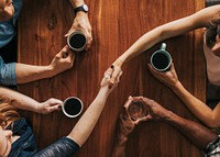 Partner shaking hands in a cafe