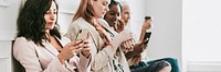 Businesswomen using digital devices while waiting