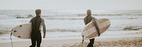 Surfers running on the beach