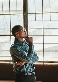 Thoughtful businessman standing by a window