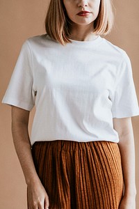 Short brown hair woman in a white tee and a brown skirt