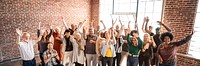 Group of diverse people standing in front of a brick wall