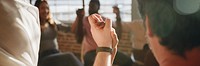 Group of diverse people holding hands up in the air