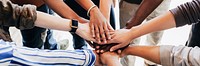 Group of diverse people stacking hands in the middle