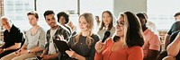 Cheerful woman speaking on a microphone in a workshop