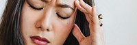 Stressed woman holding her forehead