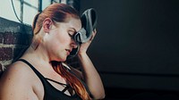 Woman wiping away her sweat with a gym towel wallpaper