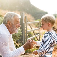 Granddad and grandson at a countryside farm