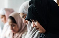 Muslim women praying in Tashahhud posture