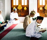 Muslim men reading Quran during Ramadan