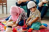 Muslim family relaxing and playing at home