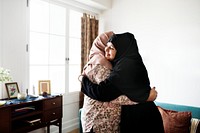 Muslim women hugging each other