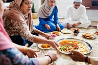 Muslim family having dinner on the floor