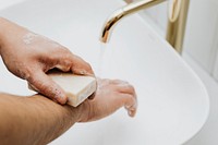 Man using a bar soap to wash his hands