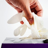 Woman taking disposable gloves from the box  