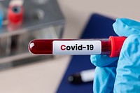 Surgeon holding a coronavirus blood test tube 