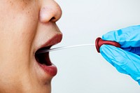 Woman getting a mouth swab to test for coronavirus