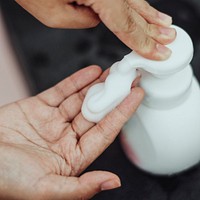 Hand pumping foam soap from a bottle 