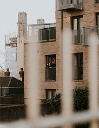 Couple standing on their balcony during self quarantine due to the covid-19 pandemic in Britain. APRIL 6, 2020 - BRISTOL, UK
