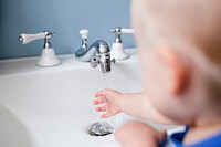 Cute little girl learning how to wash her hands in the new normal