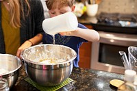 Kid learning how to bake with mom education photo