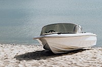 White motorboat at the shore in the summertime